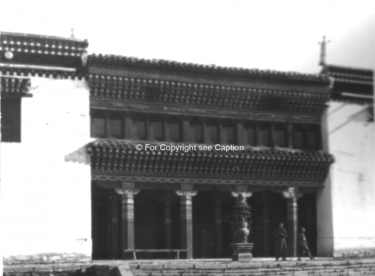 Entrance of the main assembly hall with an incense vessel and two novices. Film Archives ?